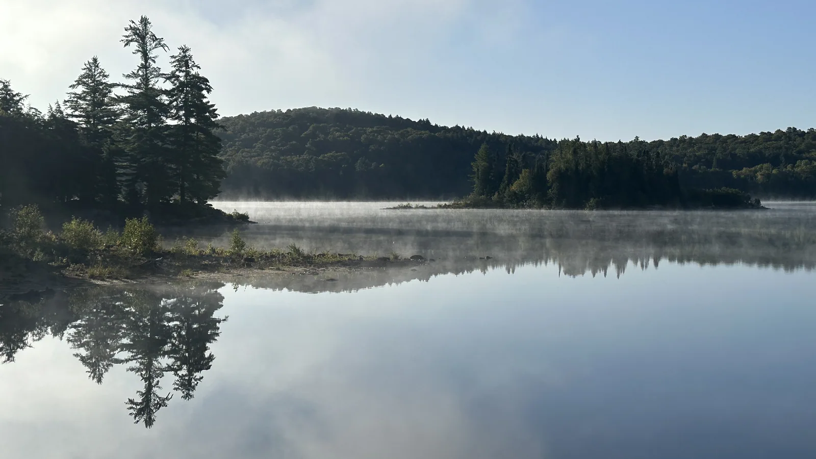 Morning mist rising off a calm Algonquin lake